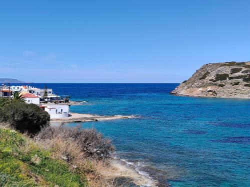 a view of the ocean with houses and a beach at Lemon & Waves Mochlos in Mochlos