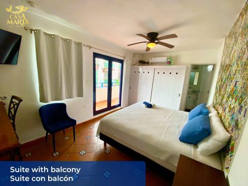 a bedroom with a bed and a ceiling fan at Casa María in Isla Mujeres