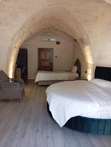 a large bedroom with two beds and an archway at Aslan Guest House in Sanlıurfa