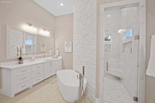 a white bathroom with a toilet and a shower at 298 5 Bedrooms Fenced yard New Construction in Robstown