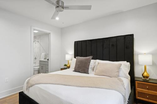 a bedroom with a large bed with a black headboard at The Eleanor New Orleans in New Orleans