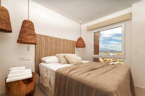a bedroom with a bed and a large window at eme de Maison - luxury only two in Arenales del Sol
