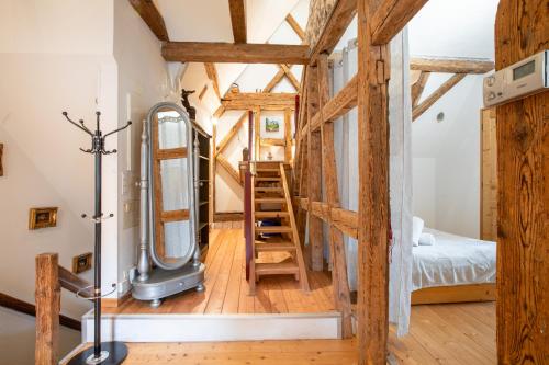 a tiny house with a ladder and a bedroom at L'Atypique au coeur du Vignoble in Hunawihr
