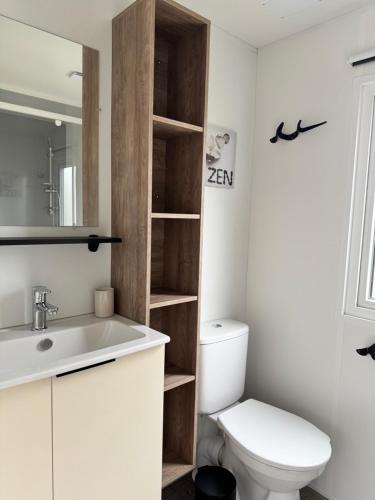 a bathroom with a toilet and a sink at Location Mobil-Home "Le Piriac'Home V2" in Piriac-sur-Mer