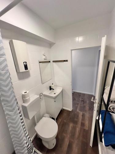 a white bathroom with a toilet and a sink at Your Home Away #Worker Accommodation in Erkrath