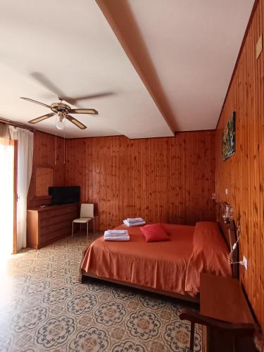 a bedroom with a bed and a ceiling fan at Il Campanile Civico 35 in Aieta