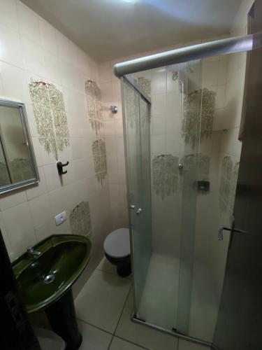 a bathroom with a shower and a sink and a toilet at Suite linda completa in Curitiba