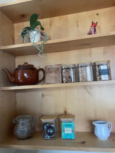 a wooden shelf with various items on it at Pika's Place Bed and Breakfast in Canmore