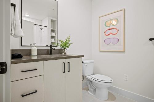 a white bathroom with a toilet and a sink at Mountain View Golf Haven Pt C105 Wkly Disc in Eden