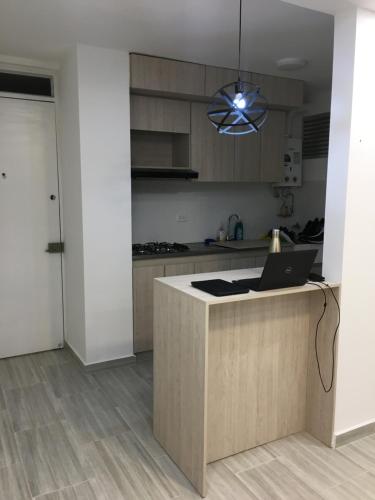 a kitchen with a counter with a laptop on it at Quedate con Yey in Chía