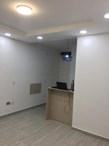 an office with a desk and a laptop on a wall at Quedate con Yey in Chía