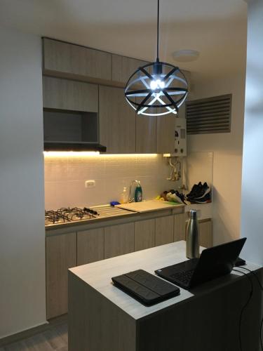 a kitchen with a laptop on top of a counter at Quedate con Yey in Chía