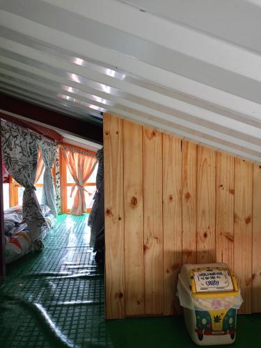 a room with a wood paneled wall in a boat at Posada Las Montañas del Edén in Ubalá