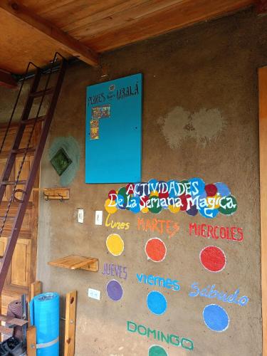 a wall with signs on the side of a building at Posada Las Montañas del Edén in Ubalá