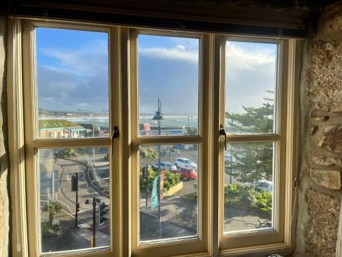 a window with a view of a city at The Wheel House in Penzance