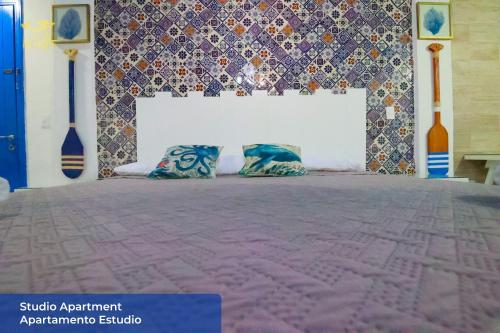 a bed with two pillows in a room at Casa María in Isla Mujeres