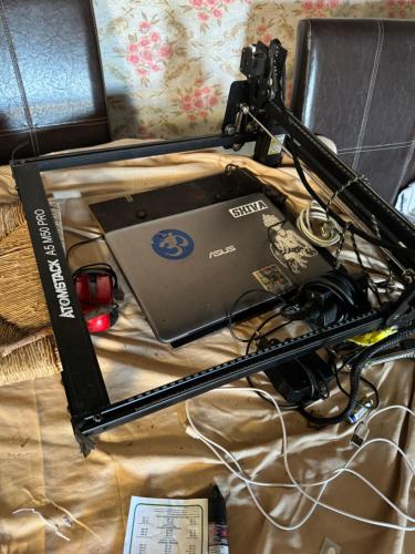 a camera and a laptop on a bed at CommunityHostel CoCreation Project in Agulo