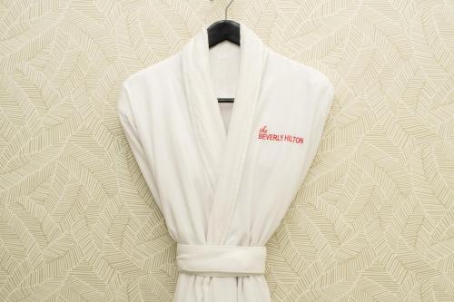 a white vest with a black tie on a wall at The Beverly Hilton in Los Angeles
