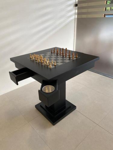 a chess board on a black table with a chessboard at Flat Studio 222 CM at Praia dos Carneiros in Tamandaré