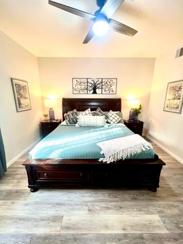 a bedroom with a bed with a ceiling fan at Supreme updated Hawkridge Condo in Mesquite