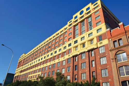a large brick building with a yellow at Darling Harbour Apartment - Weekend Getaway in Sydney