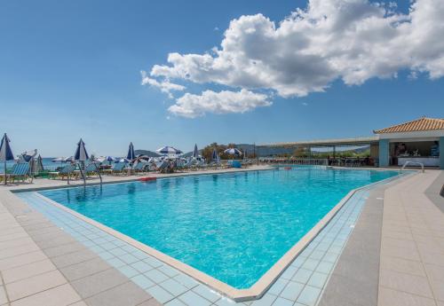 a large swimming pool with blue water in a resort at Astir Palace Hotel in Laganas