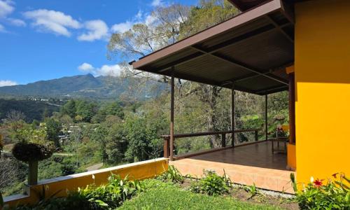 a house with a view of the mountains at El Santuario Ecolodge in Boquete