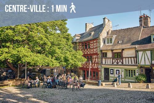 a group of people sitting at tables in front of a building at Le Cobalt - Parking Gratuit, Unique & Central in Saint-Brieuc
