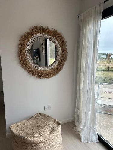 a mirror on a wall next to a window at Casa Contenedor Chapadmalal in Chapadmalal