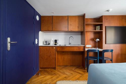 une petite cuisine avec un évier et un comptoir dans l'établissement Paris La Belle - Marais, à Paris