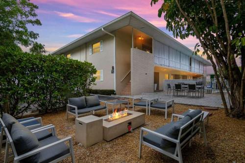 a backyard with couches and a fire pit in front of a house at Hidden Gem in Naples