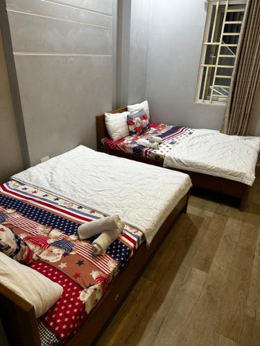 Ένα ή περισσότερα κρεβάτια σε δωμάτιο στο Mini hotel Trịnh Huỳnh