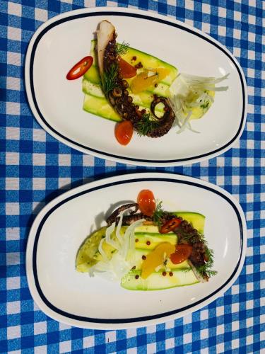 two plates of food on a blue and white table at Vila Rahmi & Veli Dervishaj in Vlorë