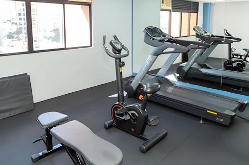 a gym with a treadmill and two exercise bikes at Flat King Vila Mariana Ibirapuera (Apto 401) in Sao Paulo