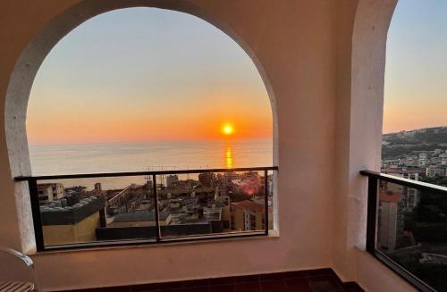 an arched window with a view of the ocean at Marbella Hotel in Jounieh
