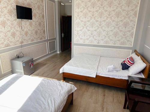 Ένα ή περισσότερα κρεβάτια σε δωμάτιο στο Mini hotel Trịnh Huỳnh