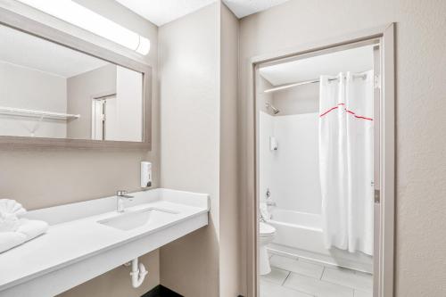 a white bathroom with a sink and a toilet at Red Roof Inn Southfield in Southfield