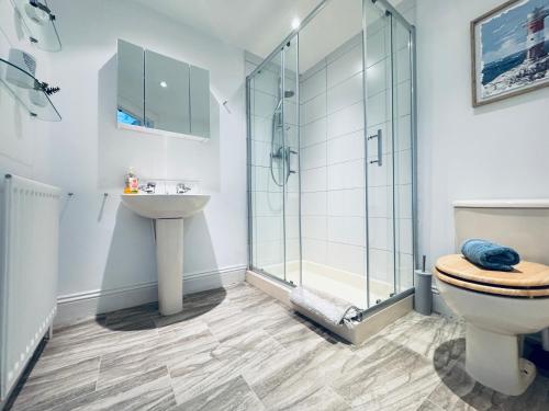 a bathroom with a shower and a toilet and a sink at Longsands Beach, Apartment 4, Tynemouth in Tynemouth