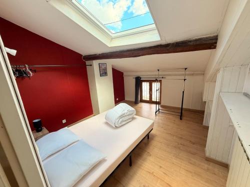 Cette chambre comprend un lit et une lucarne. dans l'établissement Cozy duplex with bar near Metz, à Ancy-sur-Moselle