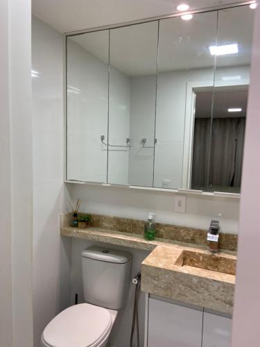 a bathroom with a toilet and a large mirror at Palazzo di Milano in Ilhéus