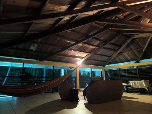 a hammock in the middle of a room at La Villa Lou, Musée Des Arts Grand Batangua in Kribi