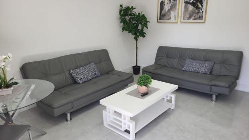 a living room with two couches and a table at Funston in Hollywood