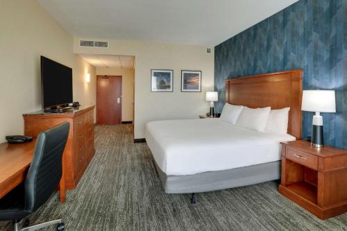 a hotel room with a bed and a desk and a computer at Drury Plaza Hotel Mt Vernon in Mount Vernon