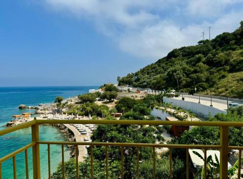 a view of the beach from the balcony of a resort at Vila Rahmi & Veli Dervishaj in Vlorë