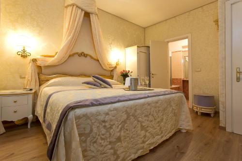 a bedroom with a bed and a dresser at Residenza Goldoni in Venice