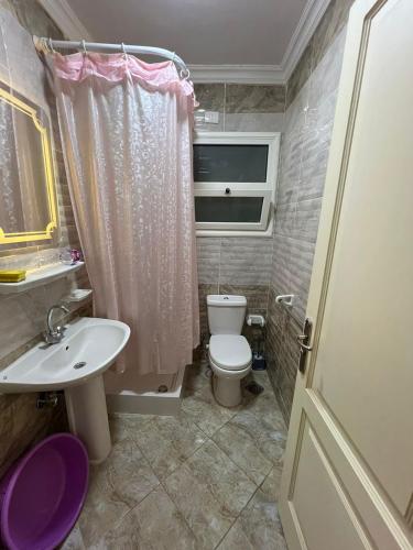 um pequeno banheiro com um vaso sanitário e uma pia em Golden Real Estate em Madinaty