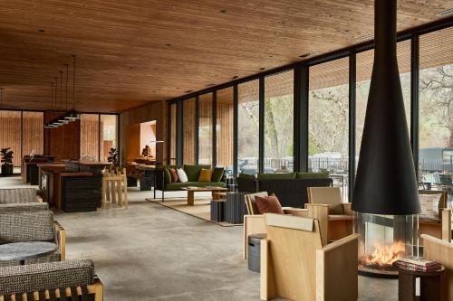 a lobby with a lot of furniture and windows at AutoCamp Sequoia in Three Rivers