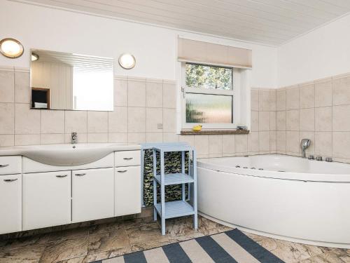 a white bathroom with a tub and a sink at 6 person holiday home in Hals-By Traum in Hals