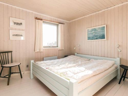 a white bed in a room with a window at Secluded Beach Retreat - By Traum Ferienwohnungen in Lihme