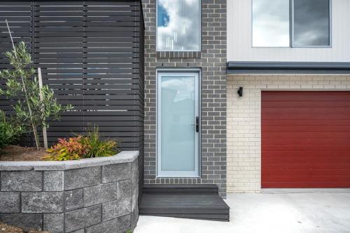 a house with a red door and a red garage at Villa 4 NEW 3Bed 2 Bath in Warrane